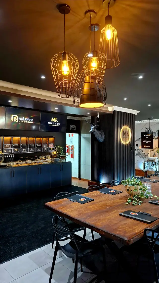 Conference centre bar counter with illuminated Xclusive Boardroom branding in Burgersfort, Limpopo