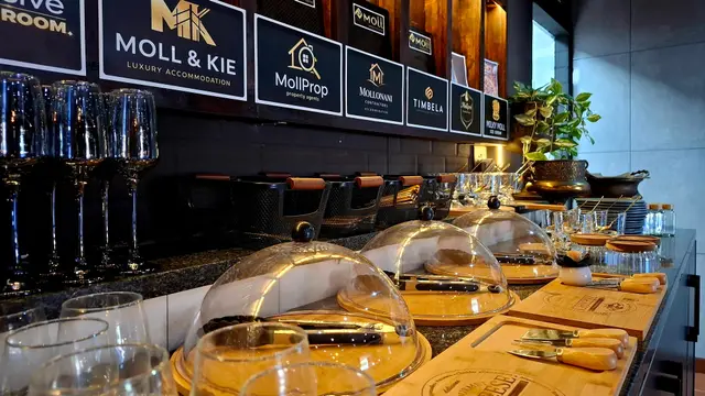 Catering counter with glass cloches and wooden serving boards for corporate meetings in Burgersfort