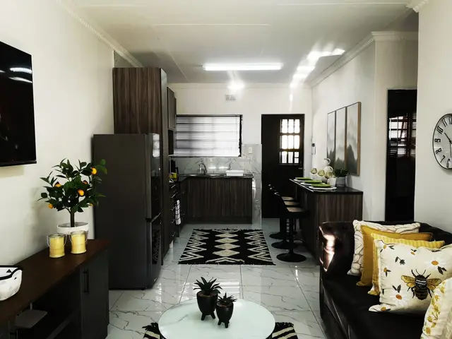 Open-plan corporate unit with modern kitchen, bar stools and marble-look floors in Burgersfort