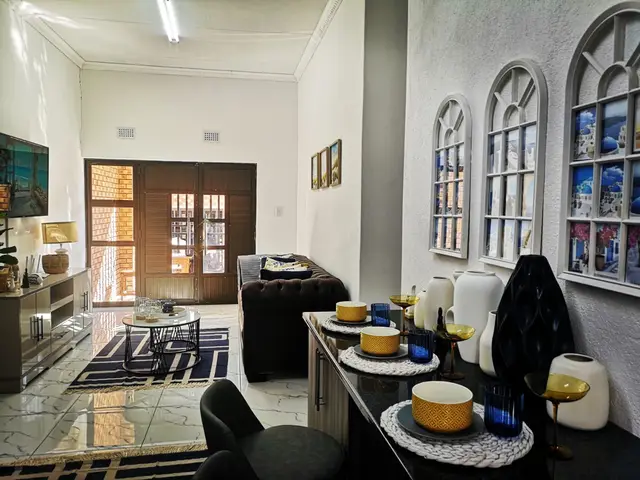 Corporate unit dining area with arched mirrors and a table set for guests