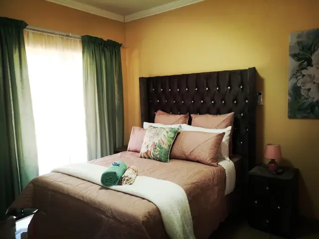 Bright bedroom with plush bedding and garden-facing window at Moll & Kie Burgersfort