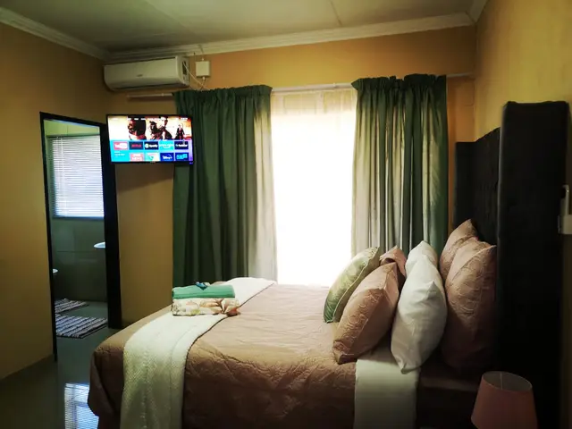 Air-conditioned bedroom with TV and en-suite access in a Burgersfort guest unit