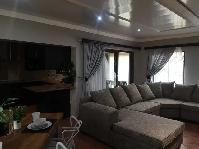 L-shaped lounge filled with natural light in a monthly rental unit